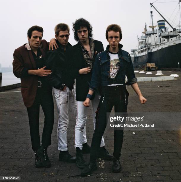 British punk group The Clash on a quayside in New York Harbor, 1978. Left to right: singer Joe Strummer , bassist Paul Simonon, guitarist Mick Jones...