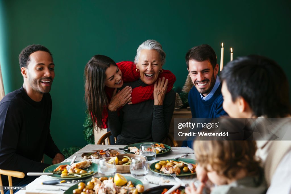 Multiracial family enjoying dinner party on Christmas vacation