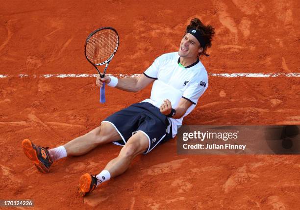 David Ferrer of Spain celebrates match point during the men's singles semi-final match against Jo-Wilfried Tsonga of France on day thirteen of the...