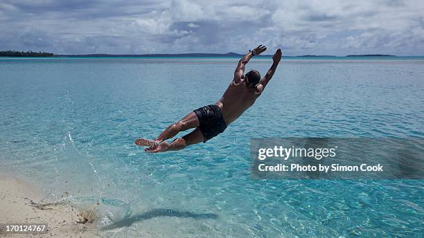 diving into lagoon - aitutaki stock pictures, royalty-free photos & images