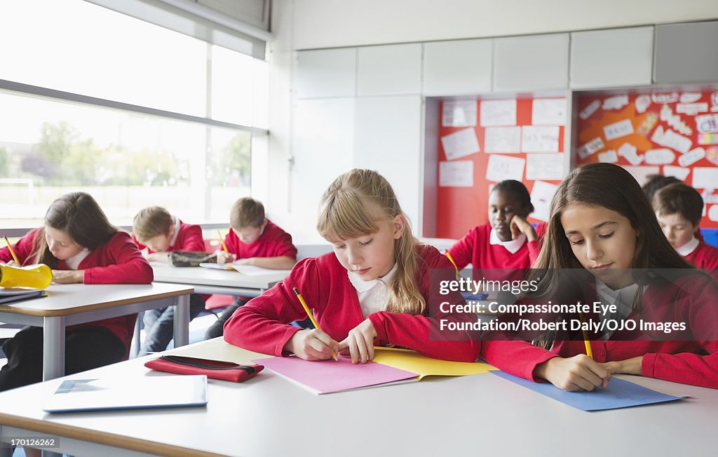 Students writing in classroom