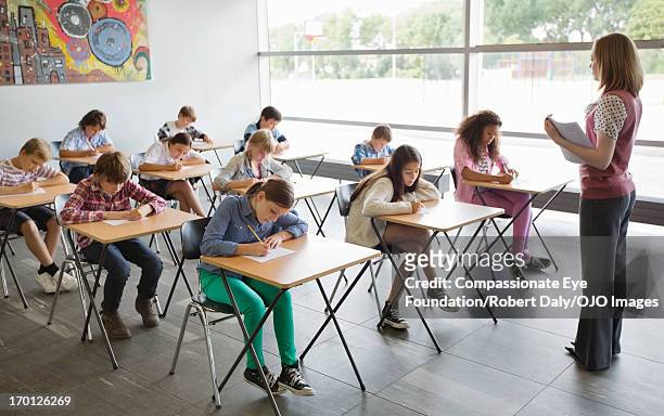 students taking a test in classroom - school exam stockfoto's en -beelden