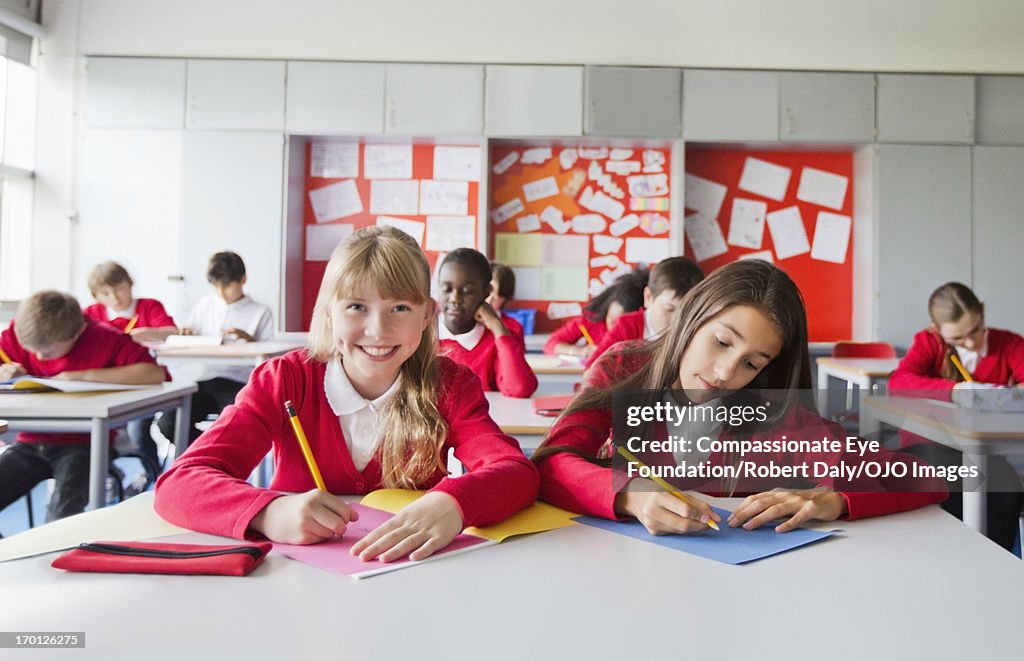 Students writing in classroom