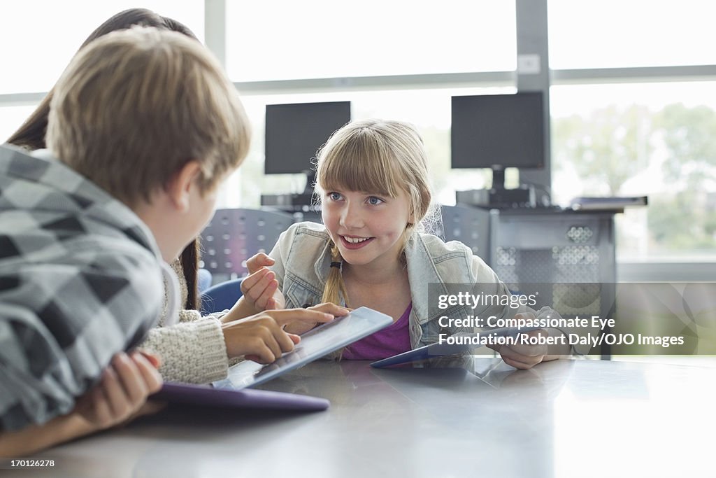 Students using digital tablets in classroom