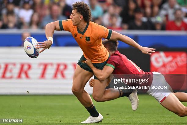 Australia's right wing Mark Nawaqanitawase is tackled by Portugal's left wing Rodrigo Marta during the France 2023 Rugby World Cup Pool C match...