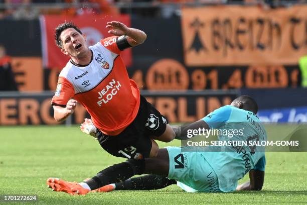 Lorient's French midfielder Laurent Abergel is tackled by Montpellier's Malian defender Boubakar Kiki Kouyate during the French L1 football match...