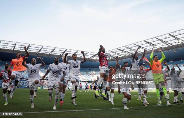 Lille's players celebrate their victory at the end of the French L1 football match between Le Havre AC and Lille OSC at The Stade Oceane in Le Havre,...