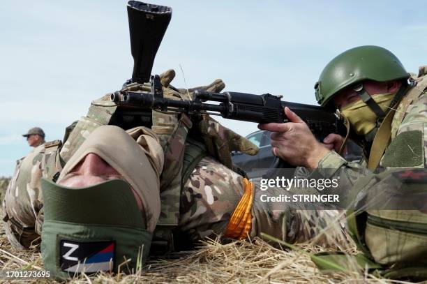 Medics, volunteers and military personnel undergo a tactical training, including first aid and the simulation of a wounded comrade evacuation, in the...