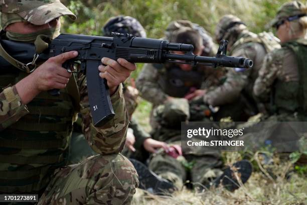 Medics, volunteers and military personnel undergo a tactical training, including first aid and the simulation of a wounded comrade evacuation, in the...