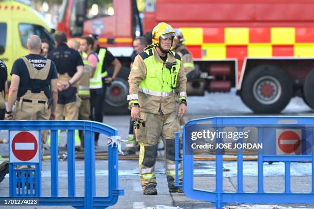 Firefighters are pictured in the street where at least thirteen people were killed in a fire at a nightclub in Murcia, on October 1, 2023. At least...