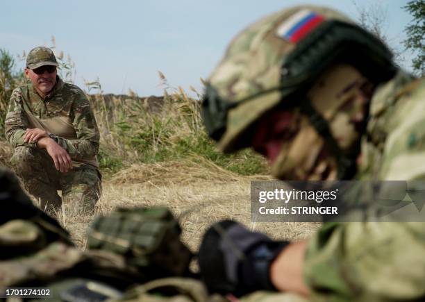 Medics, volunteers and military personnel undergo a tactical training, including first aid and the simulation of a wounded comrade evacuation, in the...