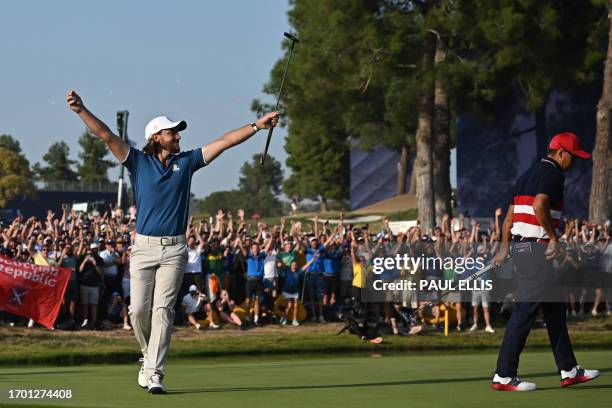 Europe's English golfer, Tommy Fleetwood celebrates the winning putt on the 17th green during his singles match against US golfer, Rickie Fowler on...