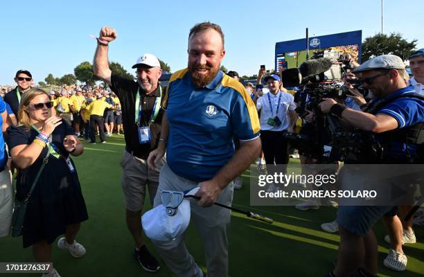 Europe's Irish golfer, Shane Lowry walks on the green as he celebrates victory after the singles matches on the final day of play in the 44th Ryder...