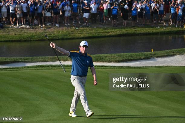 Europe's Scottish golfer, Robert MacIntyre celebrates after winning his match on the 16th green in his singles match against US golfer, Wyndham Clark...