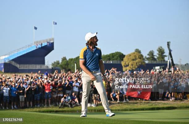 Europe's English golfer, Tommy Fleetwood celebrates after victory in his singles match against US golfer, Rickie Fowler on the final day of play in...