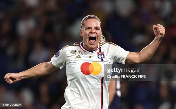 Lyon's French forward Eugenie Le Sommer celebrates after scoring the opening goal during the D1 football match between Paris Saint-Germain and Lyon...