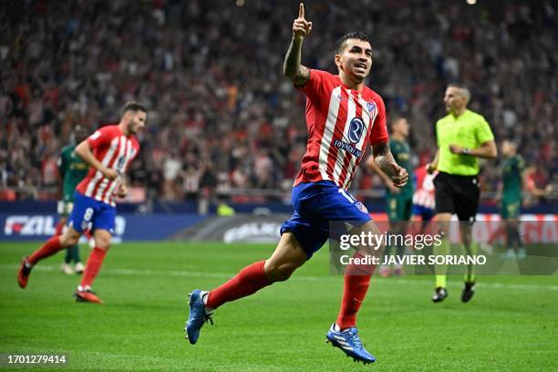 Atletico Madrid's Argentinian forward Angel Correa celebrates scoring his team's first goal during the Spanish Liga football match between Club...