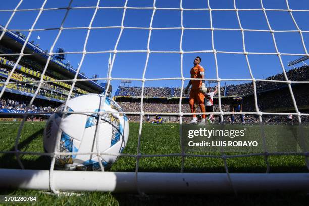 Boca Juniors' goalkeeper Sergio Romero looks at the ball after conceding a goal scored by River Plate's defender Enzo Diaz during the Argentine...
