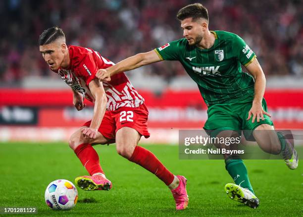 Roland Sallai of SC Freiburg and Ermedin Demirovic of FC Augsburg in action during the Bundesliga match between Sport-Club Freiburg and FC Augsburg...