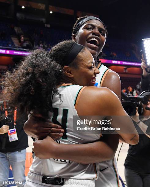 Betnijah Laney celebrates with Jonquel Jones of the New York Liberty after winning round two game four of the 2023 WNBA Playoffs against the...