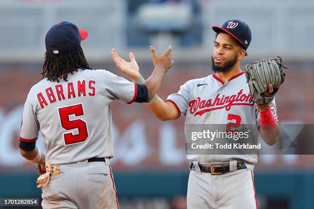 Luis Garcia of the Washington Nationals celebrates with CJ Abrams after a 10-9 victory over the Atlanta Braves at Truist Park on October 1, 2023 in...