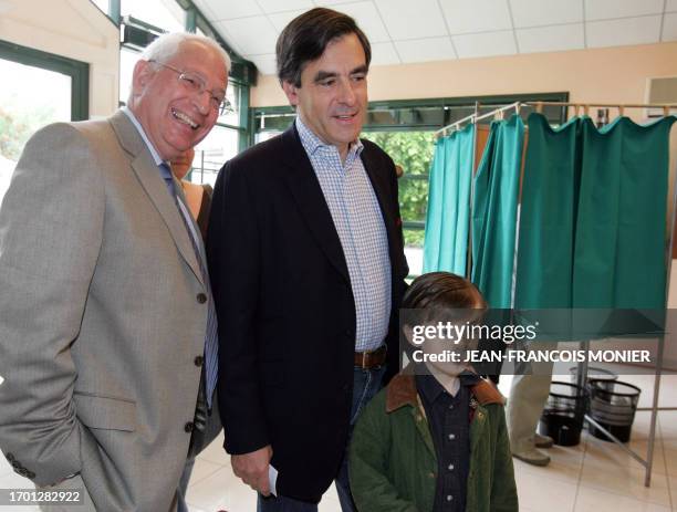 Former French minister and political advisor to Nicolas Sarkozy, Francois Fillon , next to his son Arnaud and Solesmes Mayor Roger Server , arrives...