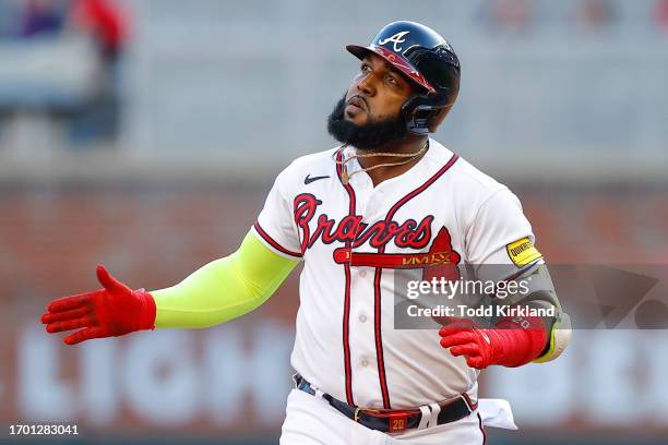 Marcell Ozuna of the Atlanta Braves reacts after hitting a home run during the ninth inning against the Washington Nationals at Truist Park on...