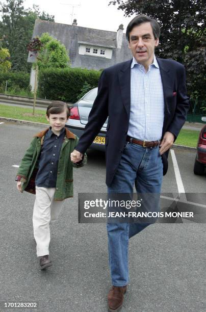 Former French minister and political advisor to Nicolas Sarkozy, Francois Fillon, next to his son Arnaud, leaves a polling station after voting, 06...