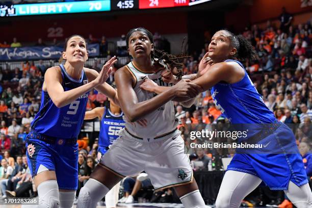 Rebecca Allen and Alyssa Thomas of the Connecticut Sun attempt to rebound the ball during the game against Jonquel Jones of the New York Liberty...