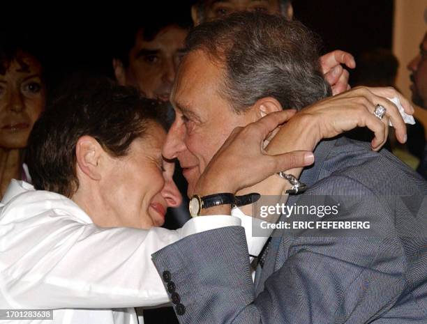 Paris Mayor Bertrand Delanoe consoles his press officer Anne-Sylvie Schneider after the official announcement that London will host the 2012 Summer...