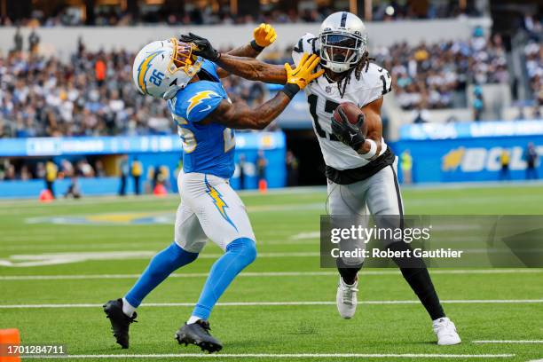 Inglewood, CA, Sunday, October 1, 2023 - TLas Vegas Raiders wide receiver Davante Adams stiff arms Los Angeles Chargers cornerback Asante Samuel Jr....