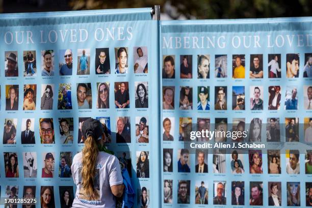 Los Angeles, CA A woman presses her face agains the photo of Vanessa Haros, who died of suicide, amidst photos on a memorial posters during the 25th...