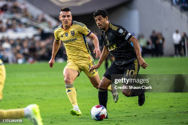 Carlos Vela of Los Angeles FC goes past Braian Ojeda of Real Salt Lake during the match at BMO Stadium on October 1, 2023 in Los Angeles, California....