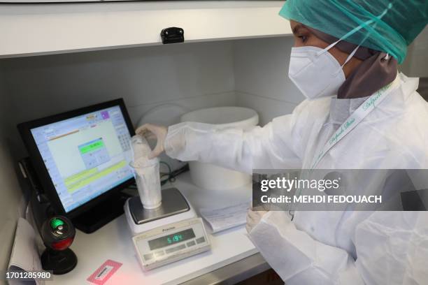 Rachida, a pharmacy technician, prepares medecines in the laboratory of the Delpech pharmacy in Paris, on September 28, 2023. Amoxicillin, corticoids...