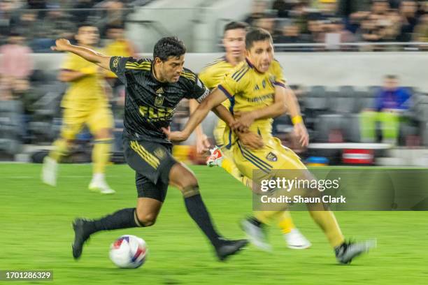 Carlos Vela of Los Angeles FC battles Jefferson Savarino of Real Salt Lake during the match at BMO Stadium on October 1, 2023 in Los Angeles,...