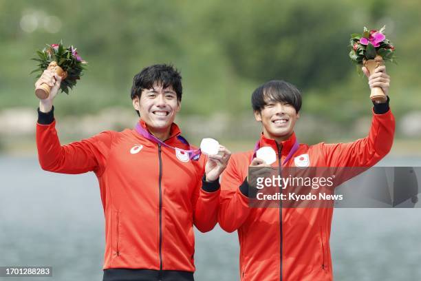 Japan's canoe sprint team of Masato Hashimoto and Ryo Naganuma pose with their silver medals after the men's canoe double 500-meter final at the...
