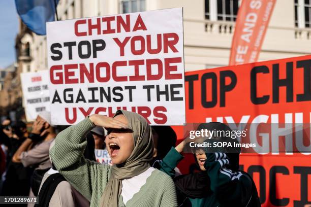 Young protesters are seen shouting slogans and holding placards to support Uyghurs during the joint rally. Hongkongers, Southern Mongolian, Tibetan,...