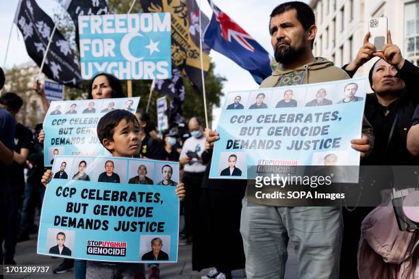 Young protester is seen holding a placard to support Uyghurs with his father during the joint rally. Hongkongers, Southern Mongolian, Tibetan, and...