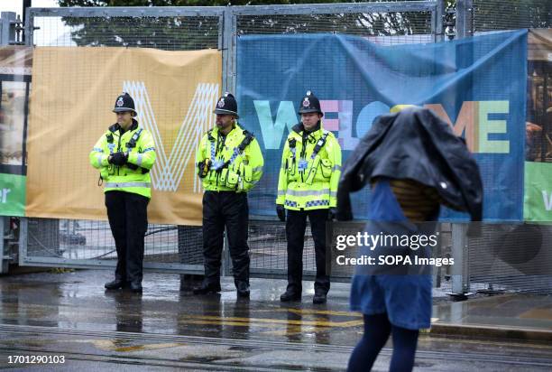 Police officers stand guard at the entry points in the fencing surrounding the Conservative party conference. Police implement a security ring of...