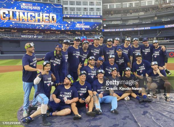 Toronto Blue Jays players pose for a team photo in Toronto, Canada, on Oct. 1 during playoff-berth celebrations following their regular-season finale...