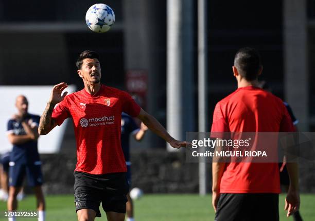 Sporting Braga's Portuguese defender Jose Fonte heads a ball during a training session on the eve of the UEFA Champions League football match between...
