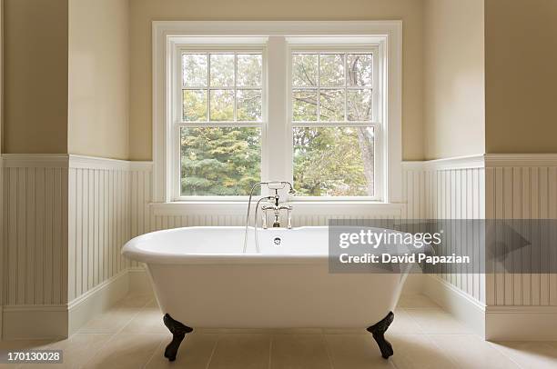 clawfoot bathtub in custom designed bathroom. - bathtub stock pictures, royalty-free photos & images