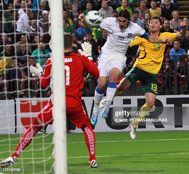 Greece's Lazaros Christodoulopoulos vies for the ball with Lithuania's Saulius Mikoliunas during the World cup 2014 football qualifying match...