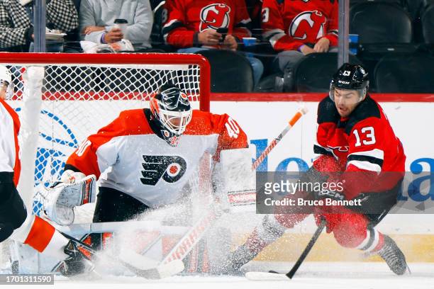 Cal Petersen of Philadelphia Flyers defends against Nico Hischier of New Jersey Devils during the first period at a preseason game at the Prudential...