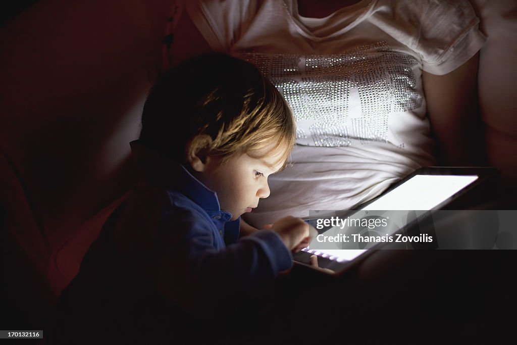 Mother and her son looking at a tablet