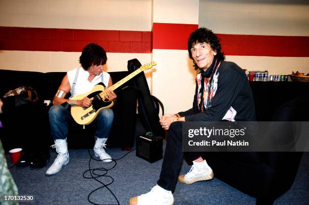 View of British musicians Jeff Beck and Ron Wood as they sit backstage at Eric Clapton's Crossroads Guitar Festival at Toyota Park, Bridgeview,...