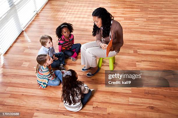 preschool children reading with teacher in classroom - two young arabic children only indoor portrait stock pictures, royalty-free photos & images