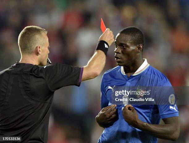 Mario Balotelli of Italy reacts as he is shown a red card by referee Svein Oddvar Moen shows the red card to during the FIFA 2014 World Cup Qualifier...