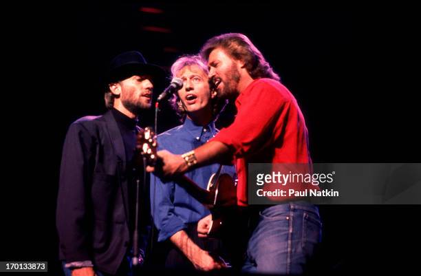 British pop group the Bee Gees perform onstage at the Poplar Creek Music Theater, Hoffman Estates, Illinois, July 31, 1989. Pictured are, from left,...