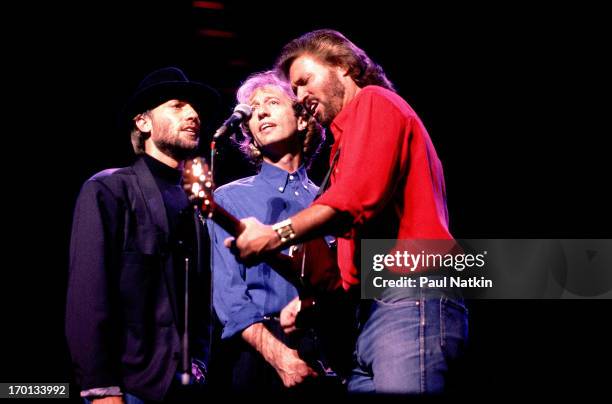 British pop group the Bee Gees perform onstage at the Poplar Creek Music Theater, Hoffman Estates, Illinois, July 31, 1989. Pictured are, from left,...